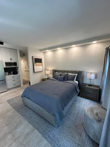 a bedroom with a large bed and a couch