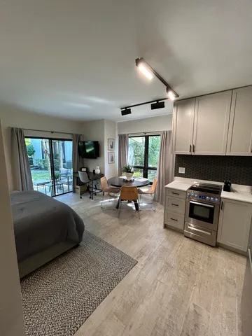 a living room with furniture a ceiling fan and a window