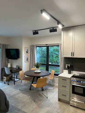 a view of a livingroom with workspace and a window