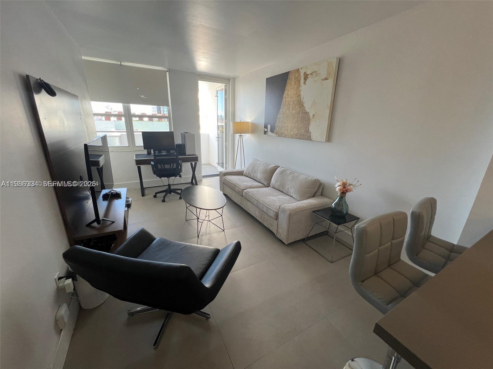 100 Lincoln Road, Unit 620 Miami Beach, FL 33139 - Photo 5 of 19 a living room with furniture and a large window