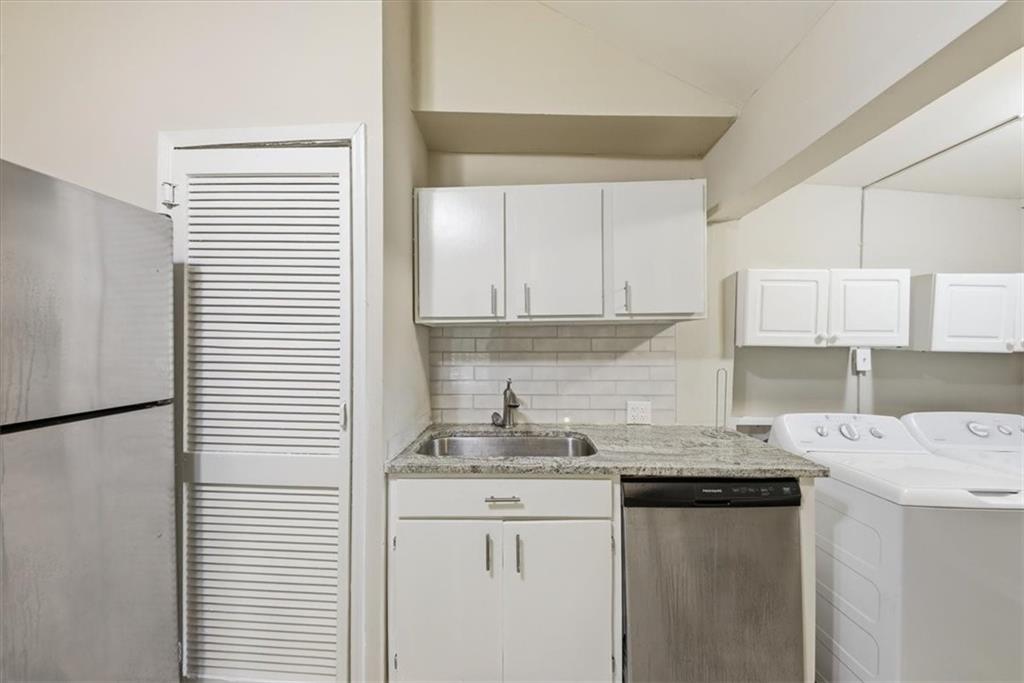 154 Lawton Street Southwest Atlanta, GA 30314 - Photo 11 of 23 a kitchen with a sink cabinets and white appliances