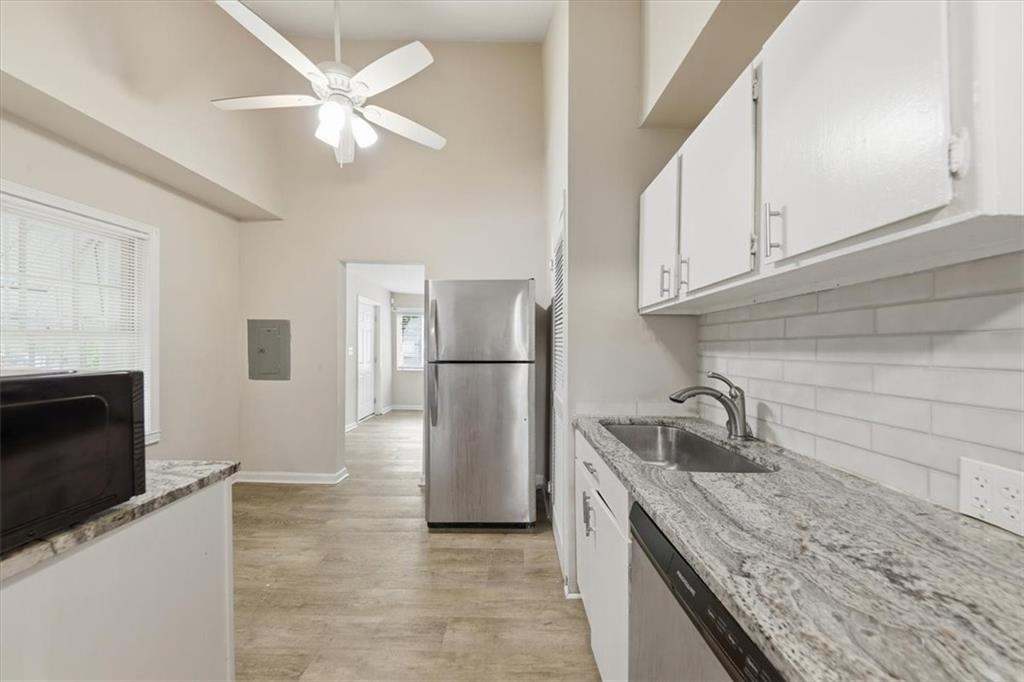 154 Lawton Street Southwest Atlanta, GA 30314 - Photo 12 of 23 a kitchen with stainless steel appliances granite countertop a sink and a refrigerator