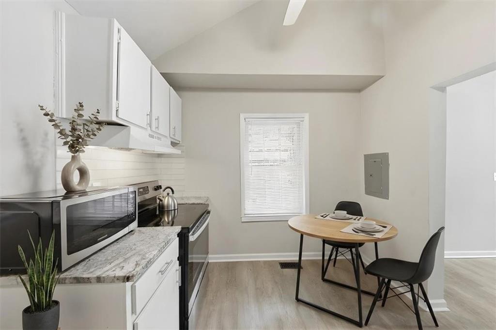 154 Lawton Street Southwest Atlanta, GA 30314 - Photo 14 of 23 a kitchen with a table and chairs in it