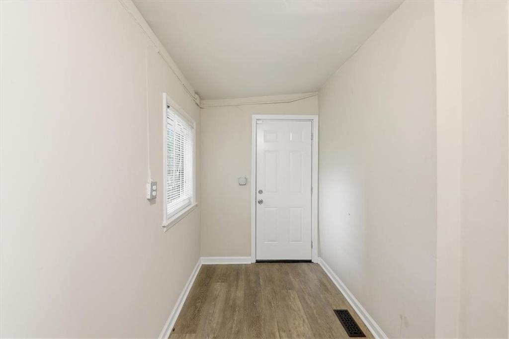 154 Lawton Street Southwest Atlanta, GA 30314 - Photo 15 of 23 a view of an empty room with wooden floor