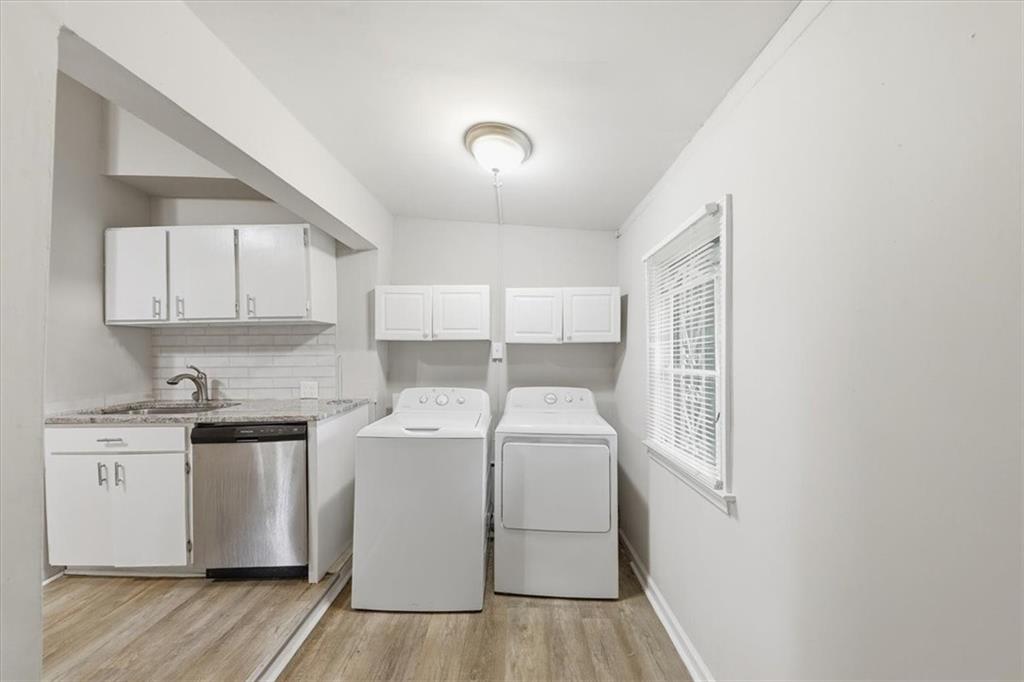 154 Lawton Street Southwest Atlanta, GA 30314 - Photo 16 of 23 a utility room with cabinets washer and dryer