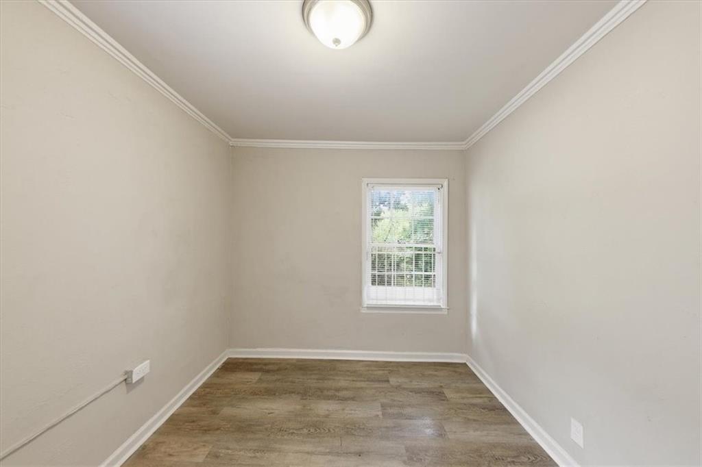 154 Lawton Street Southwest Atlanta, GA 30314 - Photo 18 of 23 an empty room with wooden floor and windows