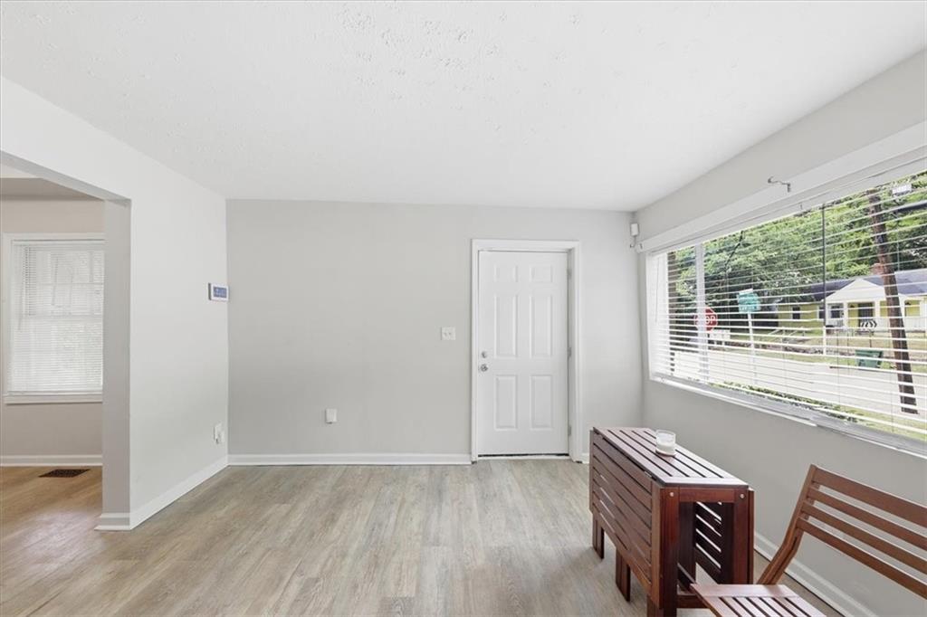 154 Lawton Street Southwest Atlanta, GA 30314 - Photo 7 of 23 an empty room with furniture and windows
