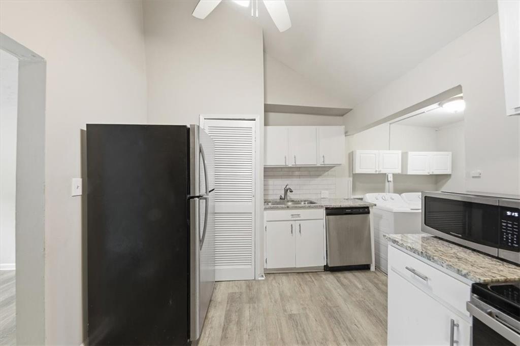 154 Lawton Street Southwest Atlanta, GA 30314 - Photo 10 of 23 a kitchen with a refrigerator sink and stove top oven