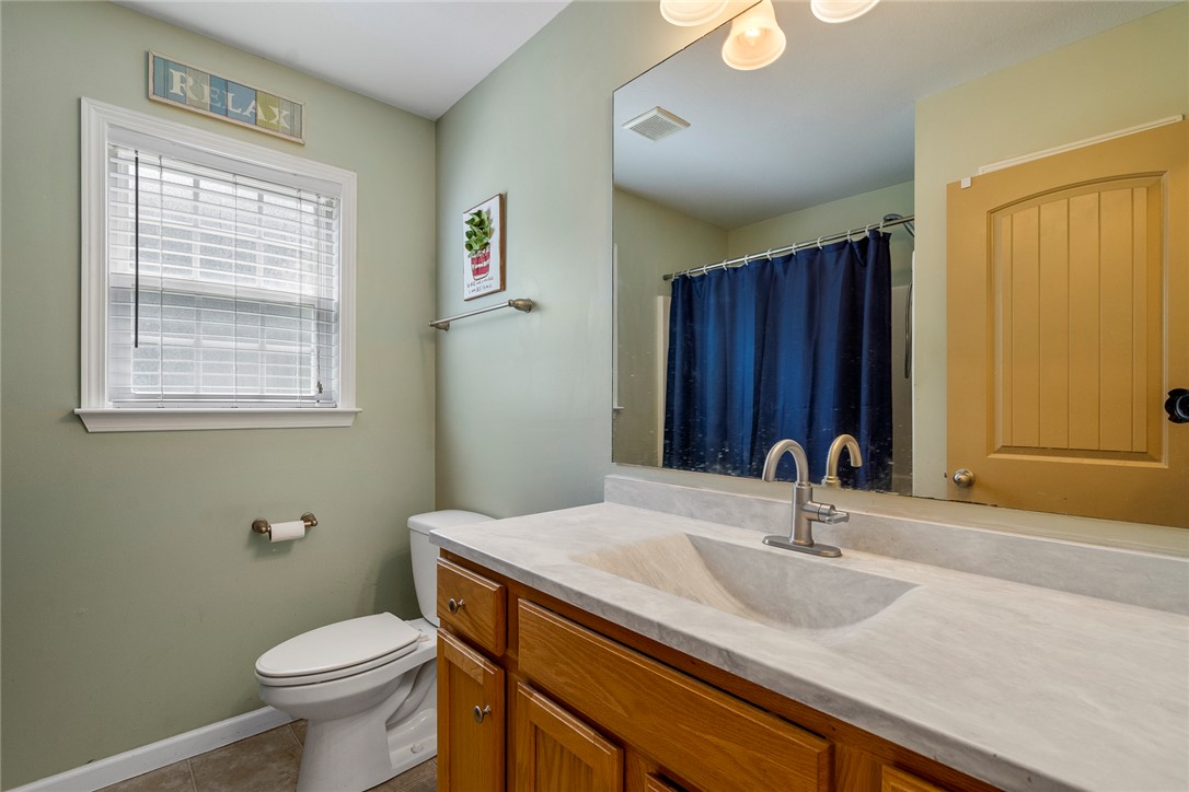 167 Mediterranean Avenue Anderson, SC 29621 - Photo 24 of 33 A window-filled bathroom offers a spacious vanity with a built-in sink.