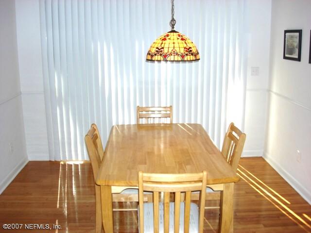4641 Morris Road Jacksonville, FL 32225 - Photo 3 of 13 a view of a dining room with furniture and wooden floor