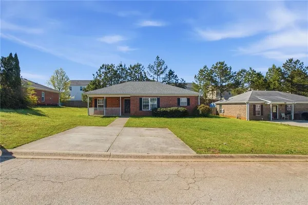 a front view of a house with a yard