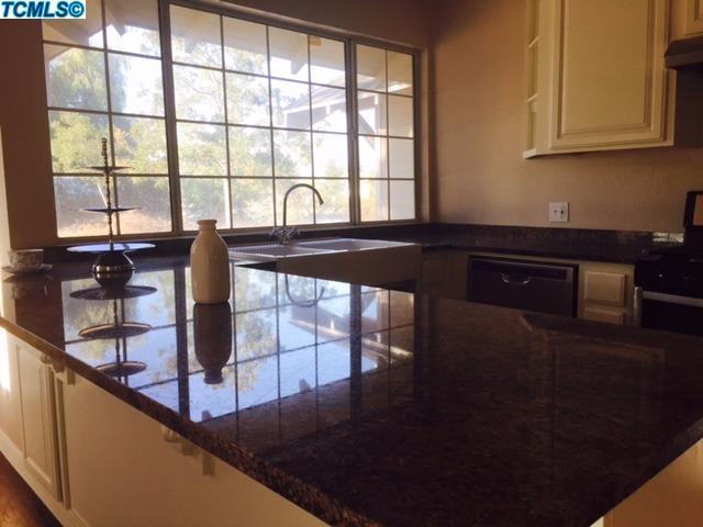 355 South Cornucopia Road Exeter, CA 93221 - Photo 4 of 26 a view of a kitchen with an empty space and a window