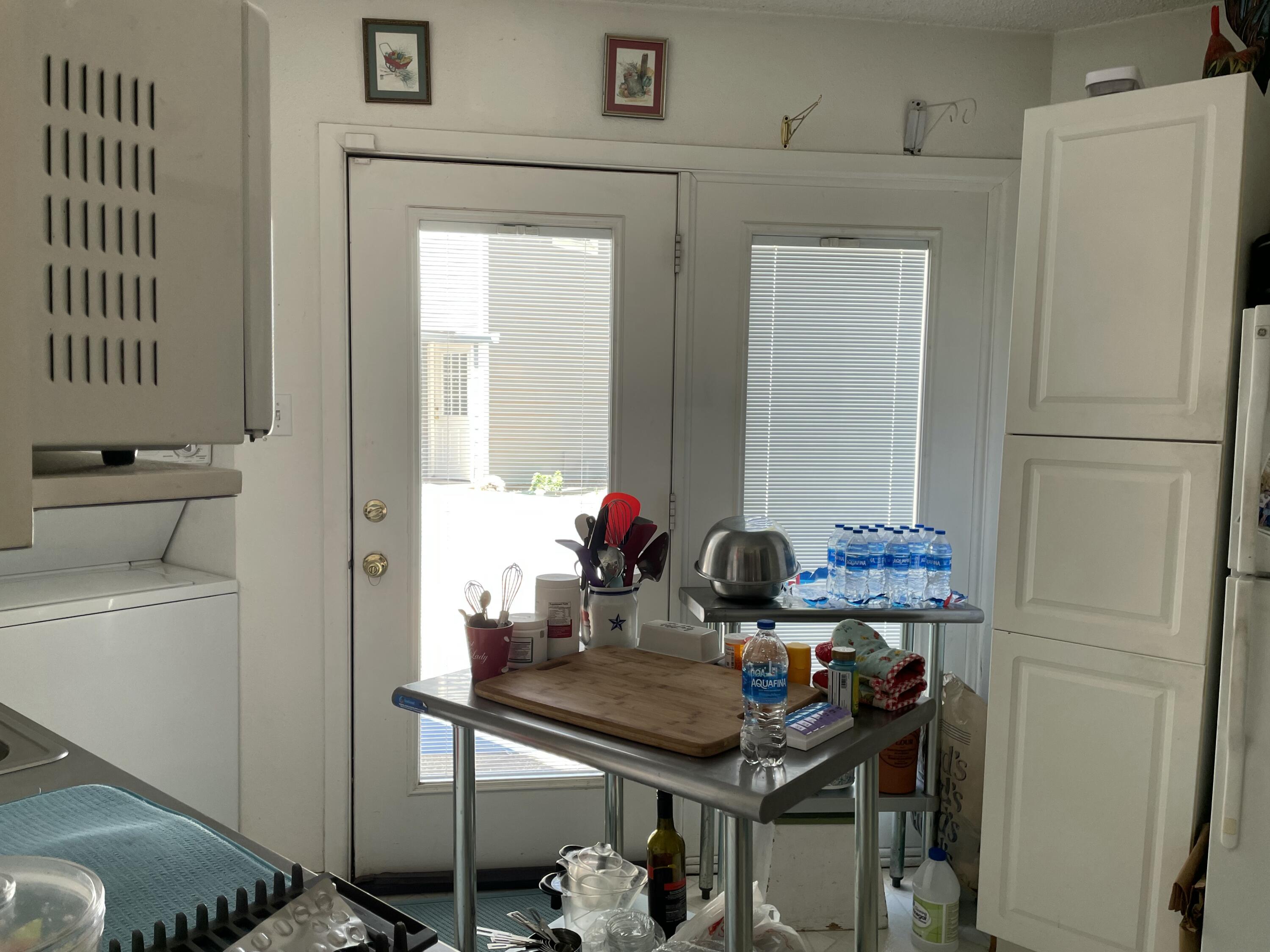 3206 21st Street Lubbock, TX 79410 - Photo 20 of 70 a view of a kitchen area with furniture and refrigerator