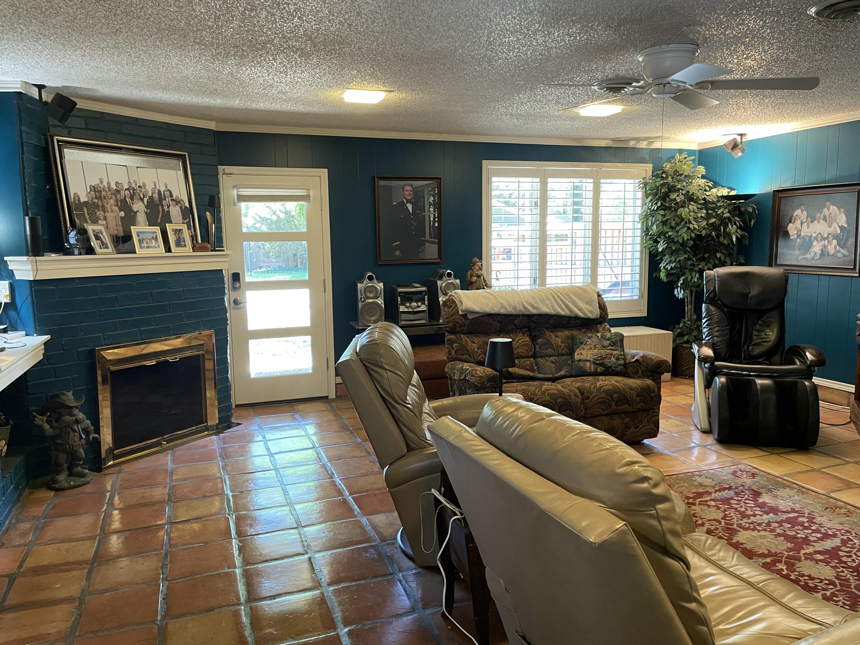 3206 21st Street Lubbock, TX 79410 - Photo 25 of 70 a living room with furniture a flat screen tv and a fireplace