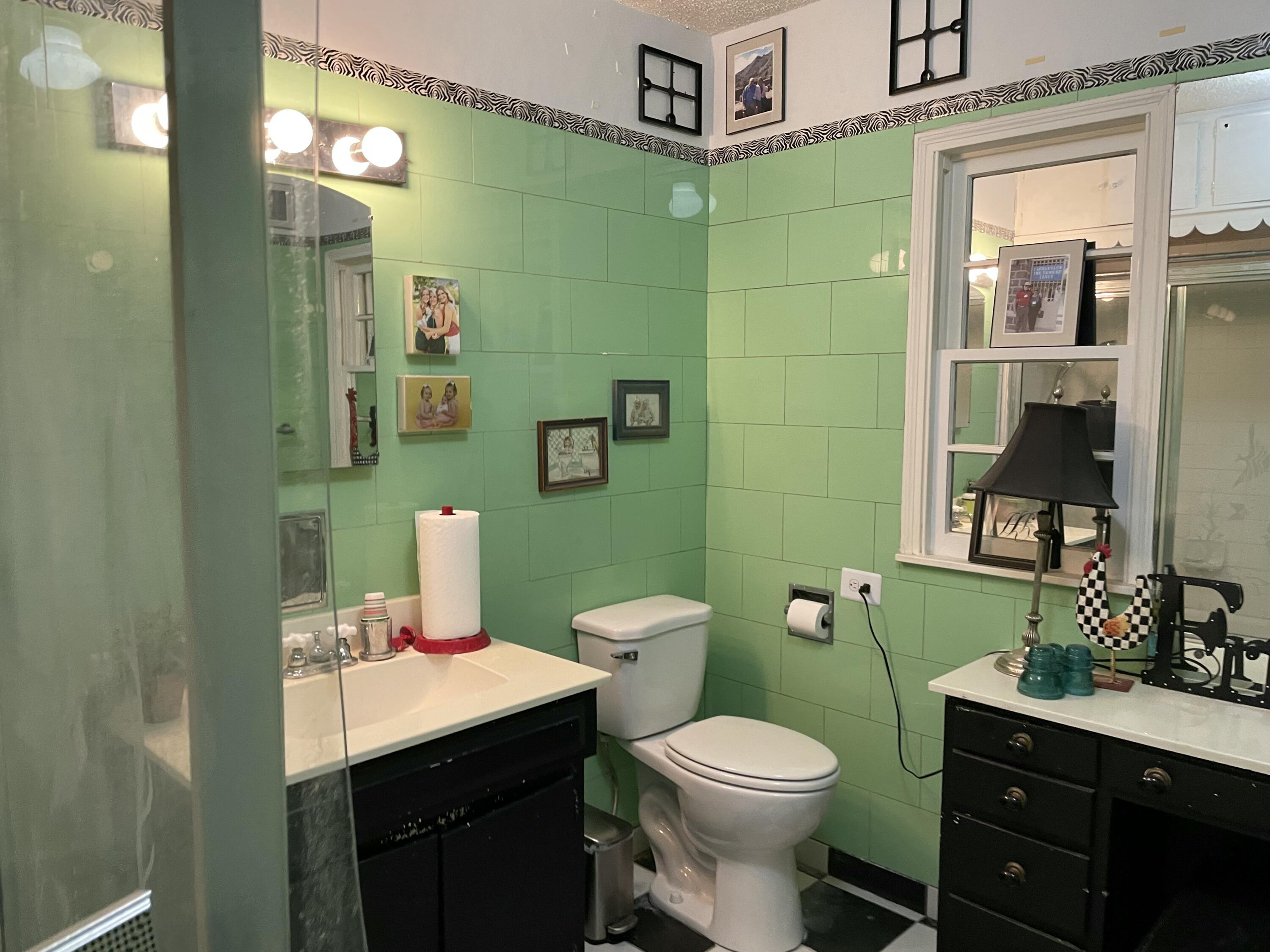 3206 21st Street Lubbock, TX 79410 - Photo 29 of 70 a bathroom with a toilet sink and mirror