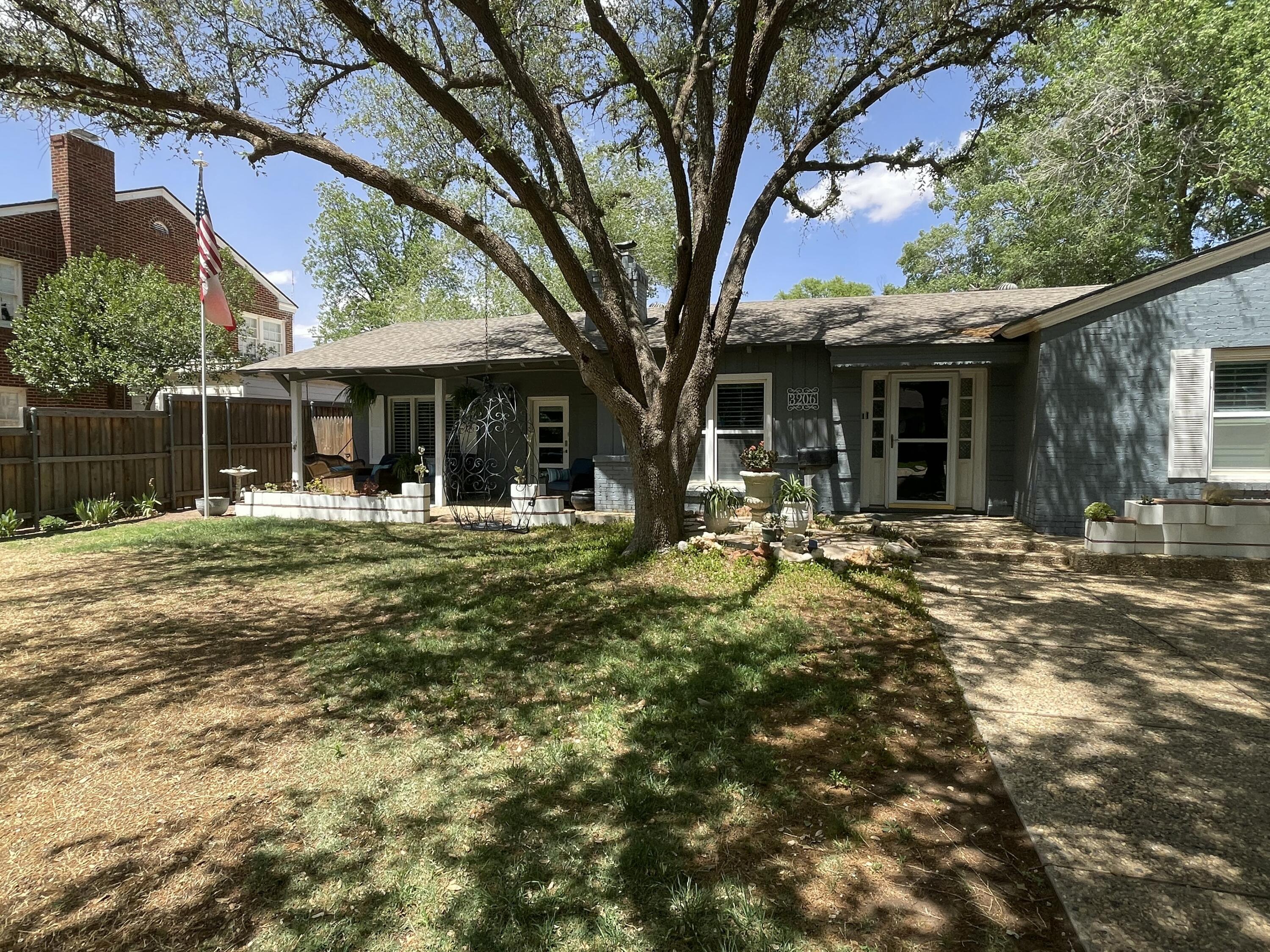3206 21st Street Lubbock, TX 79410 - Photo 4 of 70 a front view of a house with a yard