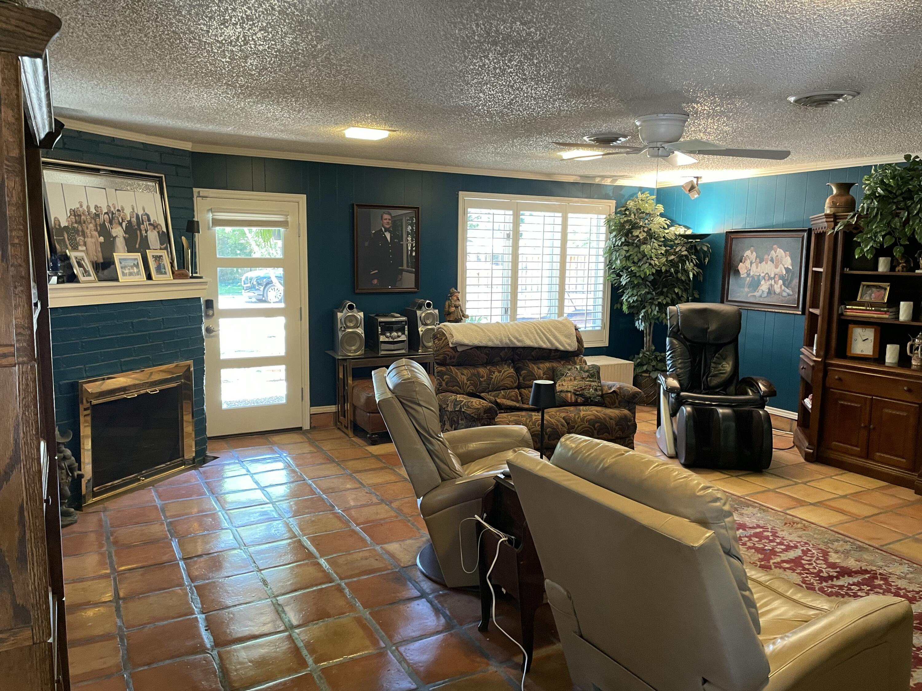 3206 21st Street Lubbock, TX 79410 - Photo 44 of 70 a living room with furniture a fireplace and a flat screen tv