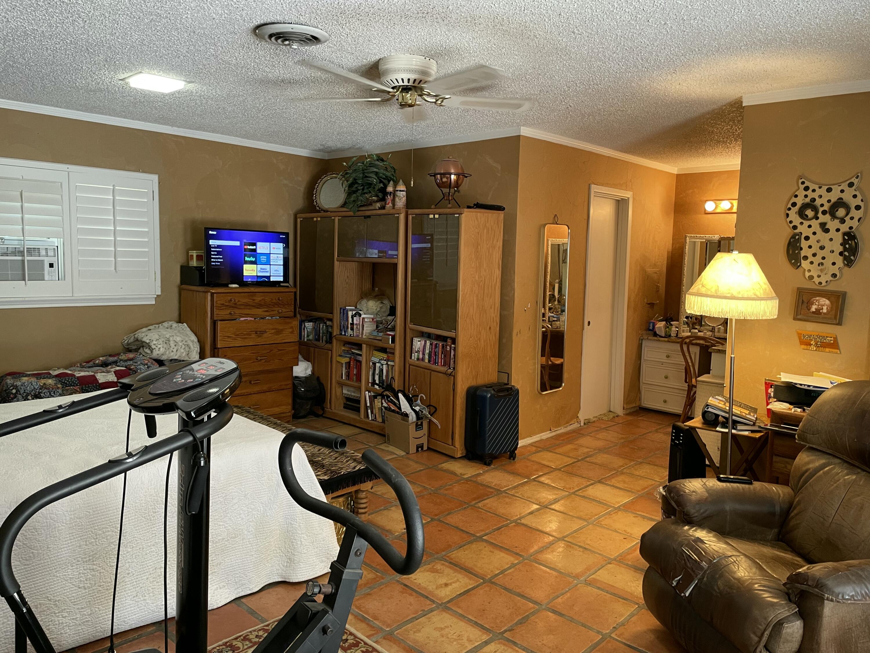 3206 21st Street Lubbock, TX 79410 - Photo 53 of 70 a living room with furniture a flat screen tv and a window