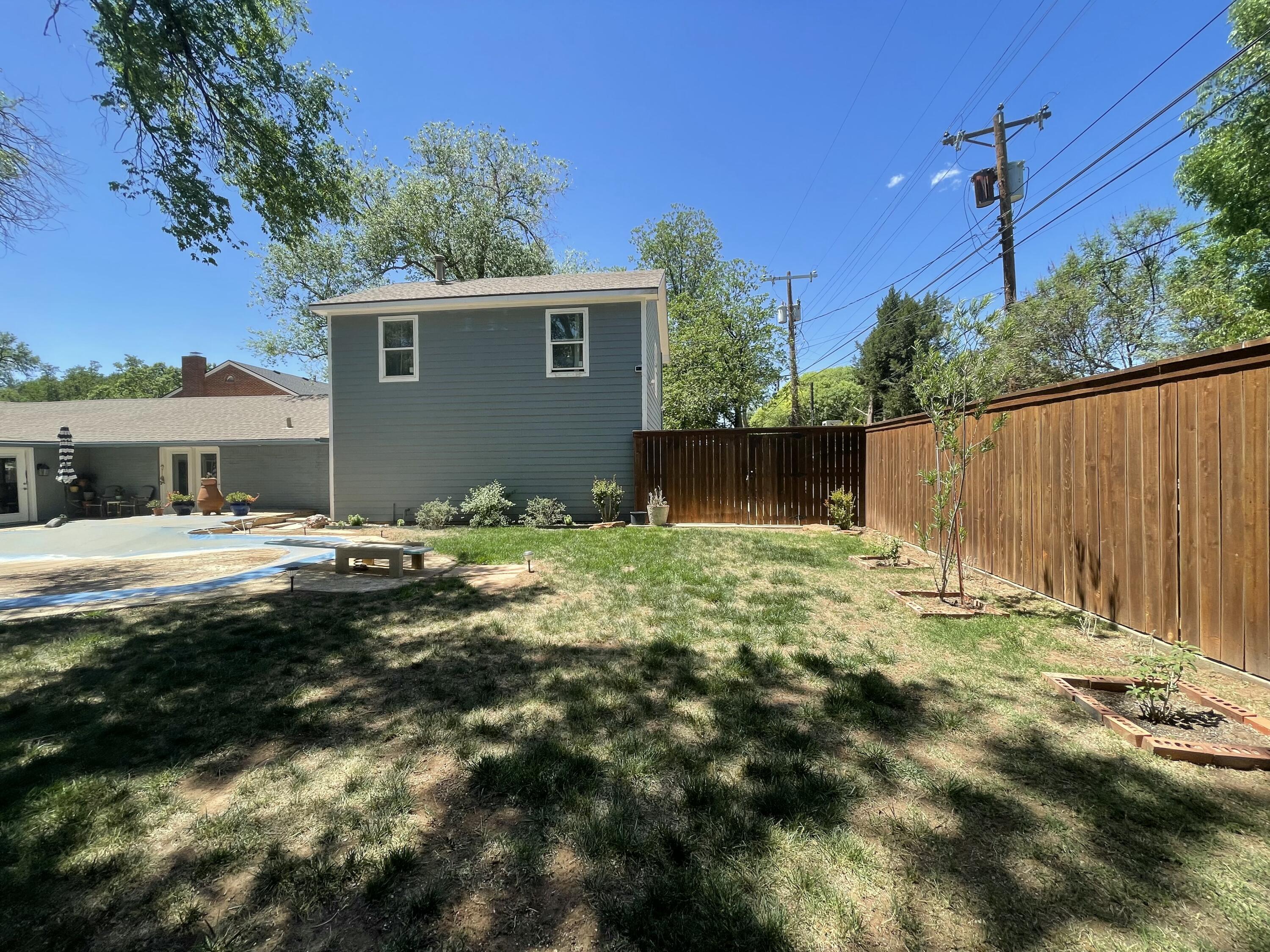 3206 21st Street Lubbock, TX 79410 - Photo 57 of 70 a backyard of a house with lots of green space