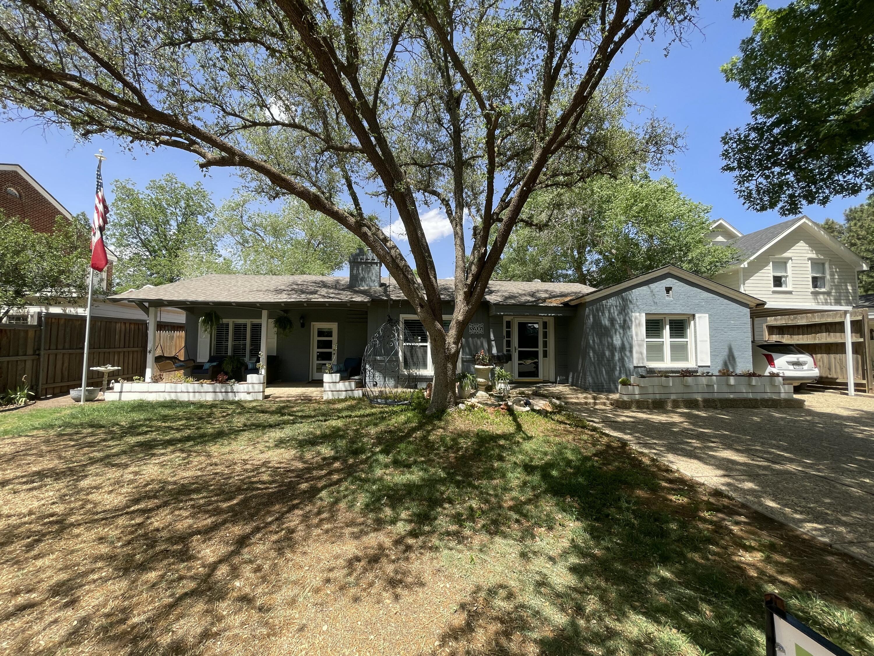3206 21st Street Lubbock, TX 79410 - Photo 6 of 70 a front view of a house with a garden