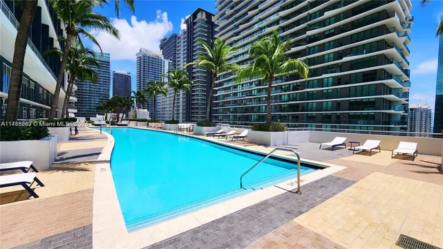 a view of a swimming pool with a lounge chair