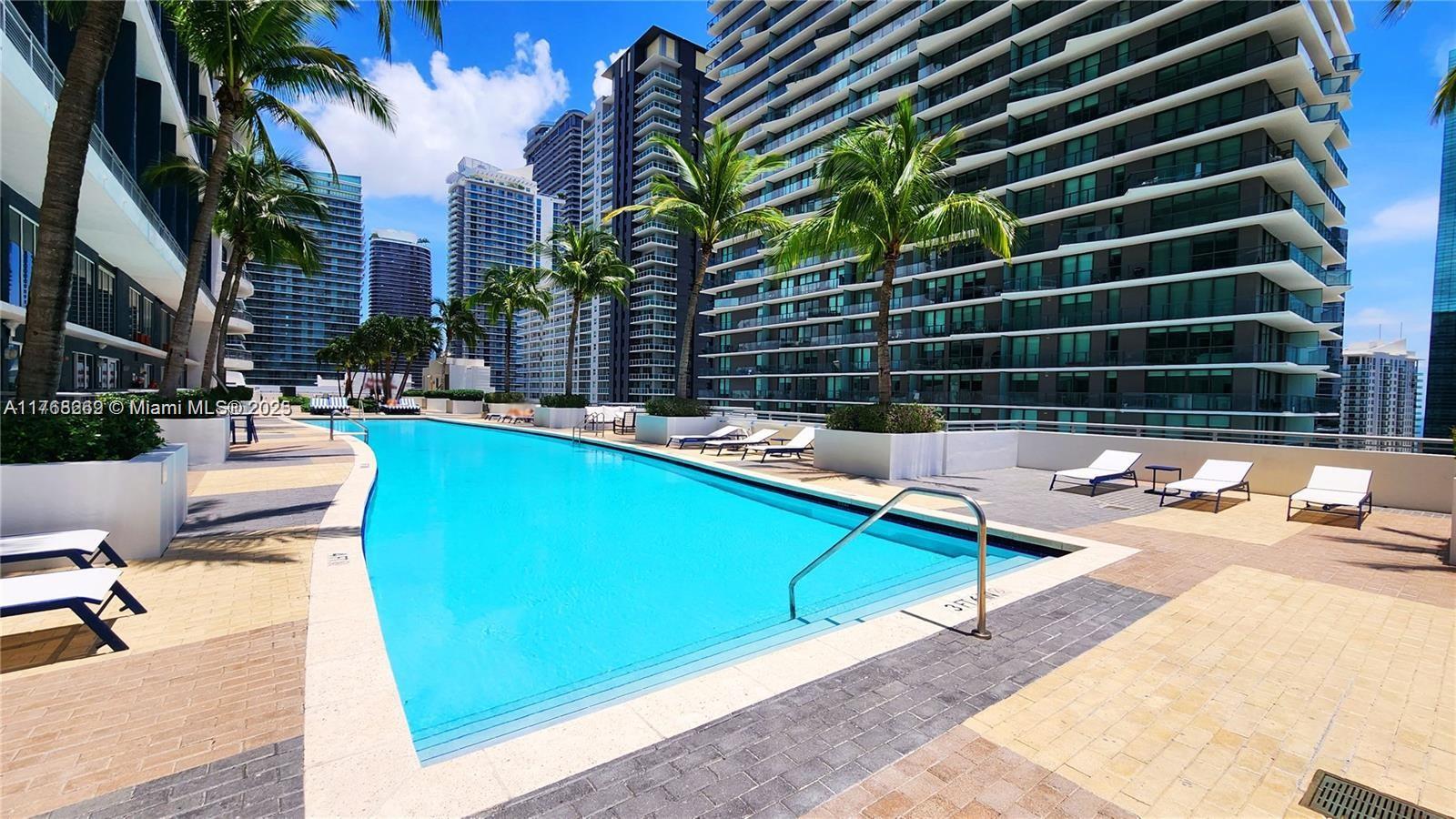60 Southwest 13th Street, Unit 1621 Miami, FL 33130 - Photo 3 of 3 a view of a swimming pool with a lounge chair