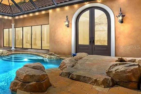 a view of a porch with wooden floor and a fireplace