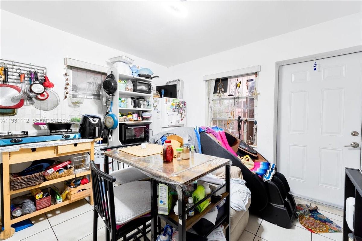 317 West 36th Street, Unit 2 Hialeah, FL 33012 - Photo 4 of 10 a room with furniture a rug toys and a dining table