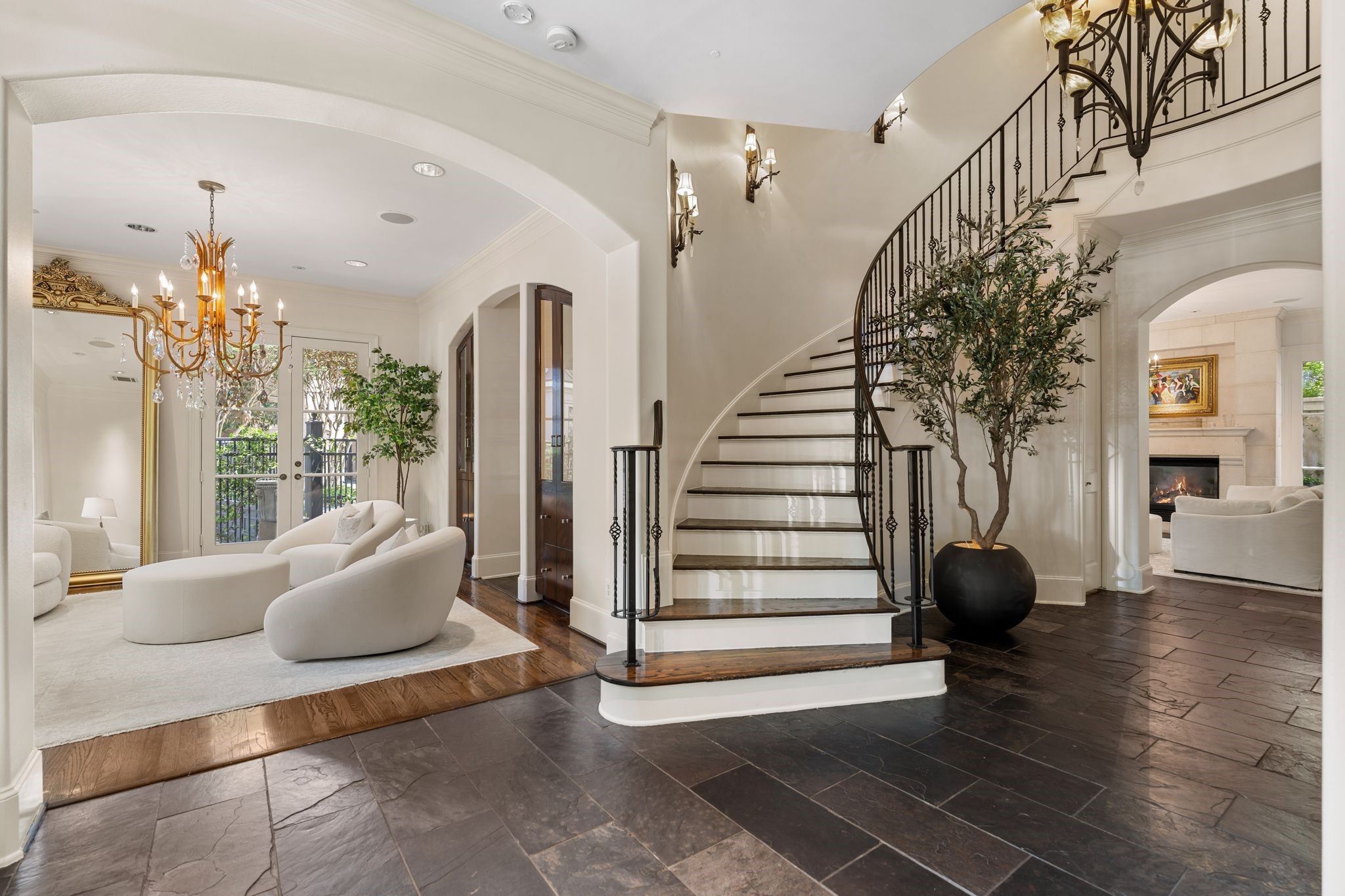 30 Hackberry Lane, Unit A Houston, TX 77027 - Photo 8 of 42 The gracious entry foyer defined by a sweeping curved staircase to all floors, takes center stage to the arched architectural openings. The refined formal living room positioned to the left is an elegant introduction to the home’s sophisticated interior.