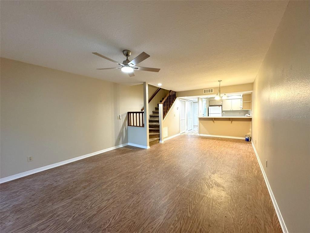 1226 Cypress Cove Court Inverness, FL 34450 - Photo 12 of 25 a view of a livingroom with wooden floor and a ceiling fan