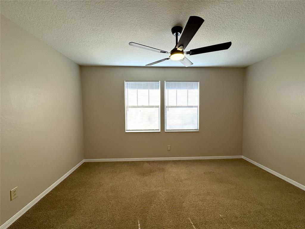 1226 Cypress Cove Court Inverness, FL 34450 - Photo 14 of 25 an empty room with a ceiling fan and window