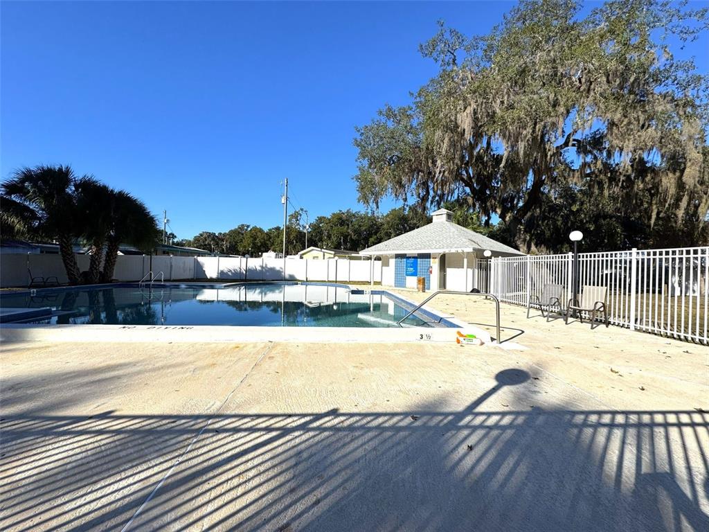 1226 Cypress Cove Court Inverness, FL 34450 - Photo 23 of 25 a view of a swimming pool with a lounge chairs