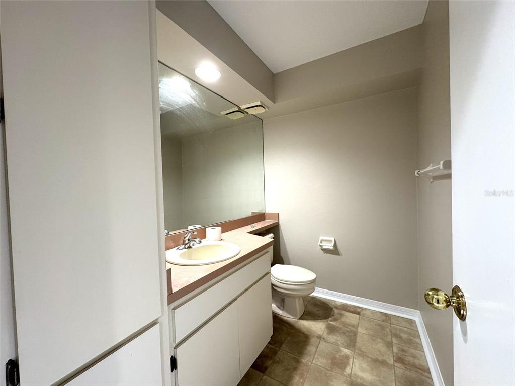 1226 Cypress Cove Court Inverness, FL 34450 - Photo 5 of 25 a bathroom with a granite countertop sink mirror vanity and toilet