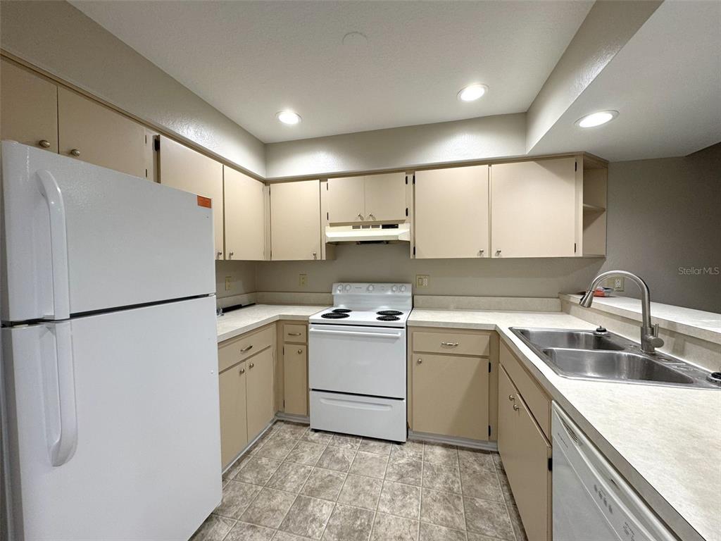 1226 Cypress Cove Court Inverness, FL 34450 - Photo 6 of 25 a kitchen with a white refrigerator and a sink