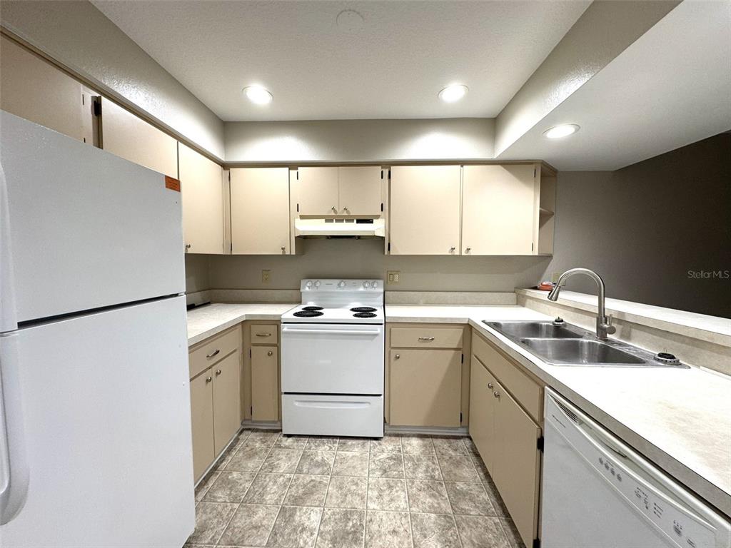 1226 Cypress Cove Court Inverness, FL 34450 - Photo 7 of 25 a kitchen that has a sink a refrigerator and a sink