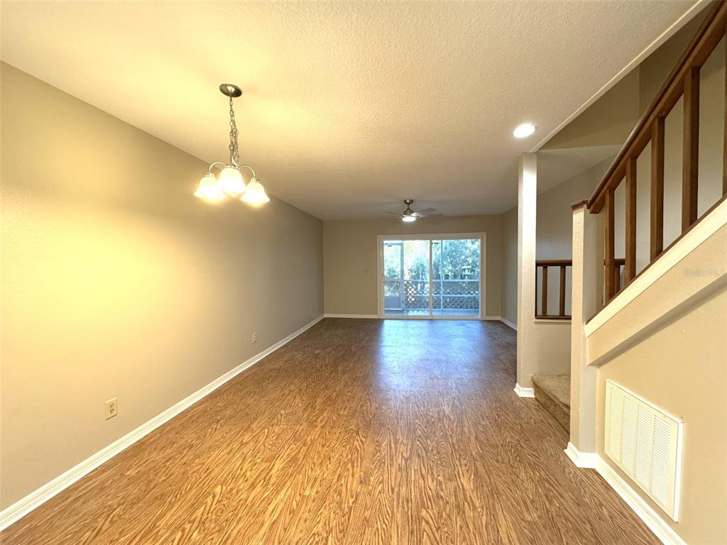 1226 Cypress Cove Court Inverness, FL 34450 - Photo 9 of 25 a view of an empty room with wooden floor and a window