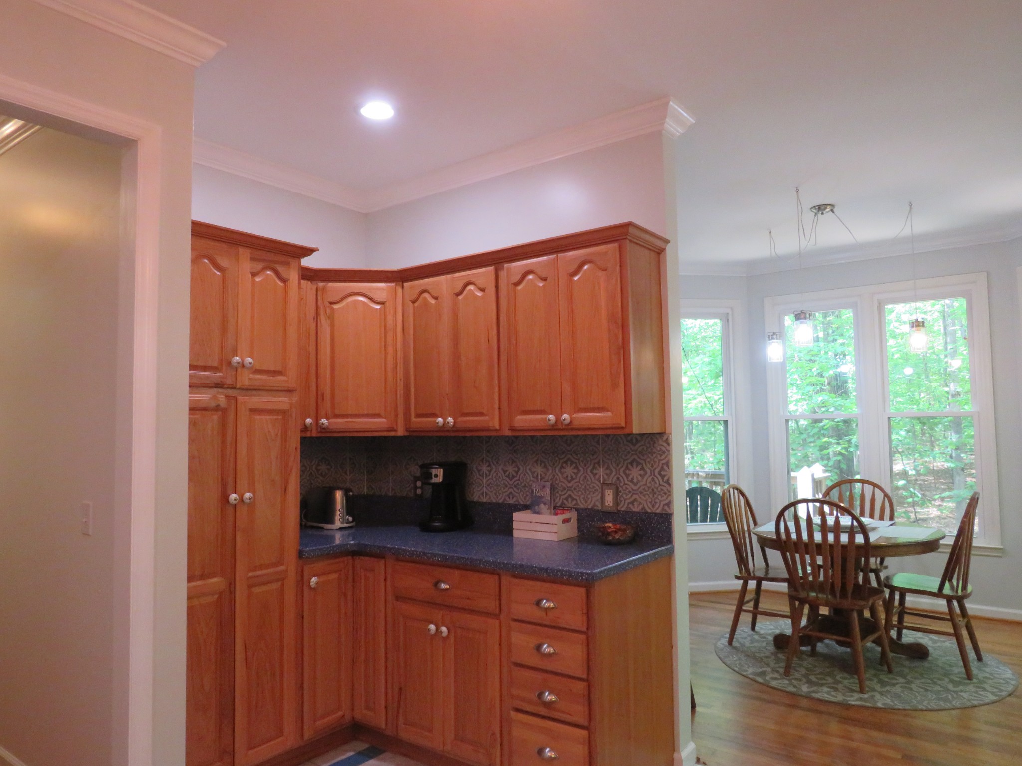 423 Bear Court Monteagle, TN 37356 - Photo 14 of 34 a kitchen with stainless steel appliances granite countertop a stove a sink a dining table and chairs with wooden floor