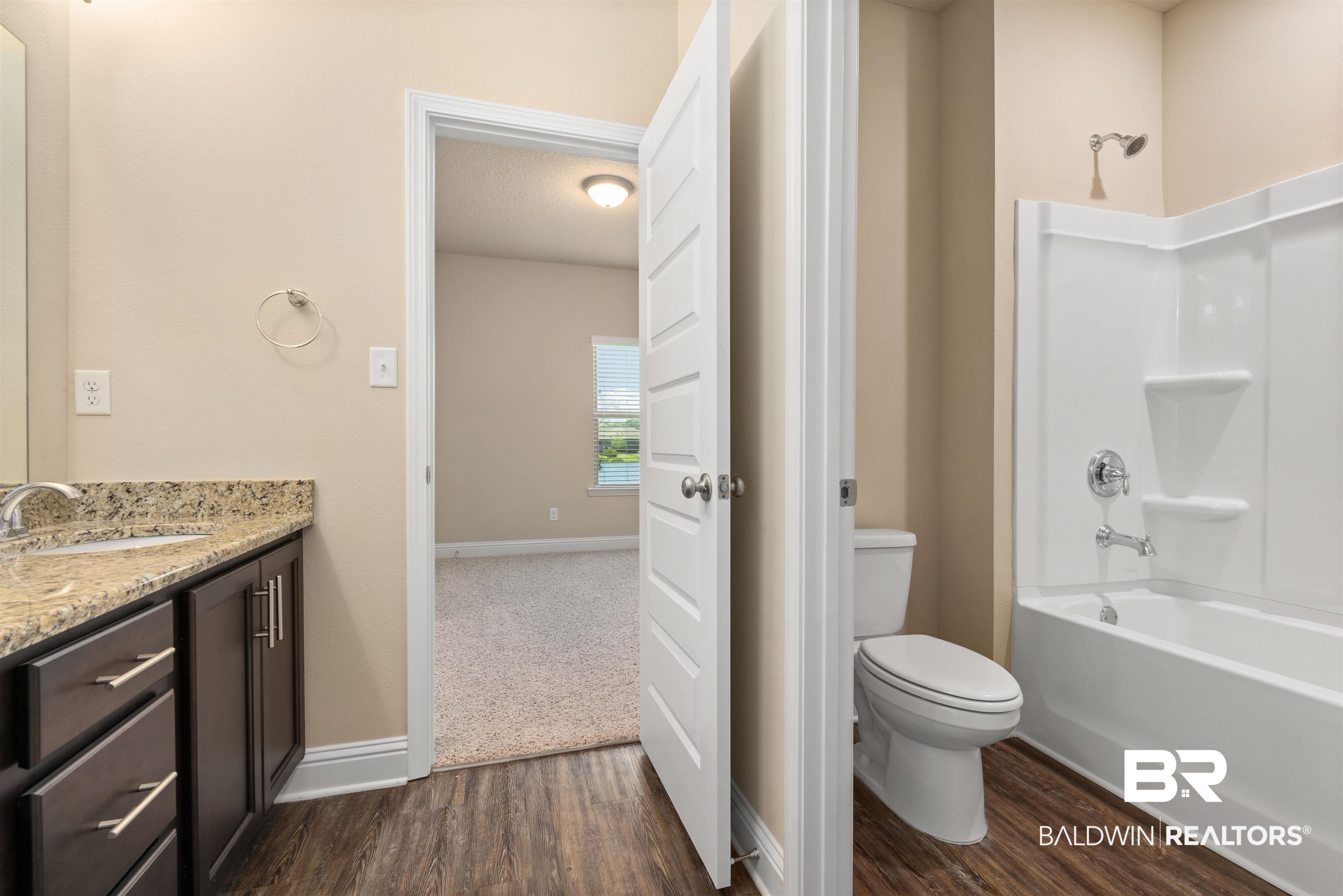 1864 Gwin Court Mobile, AL 36695 - Photo 30 of 37 Full bathroom with hardwood / wood-style flooring, vanity, tub / shower combination, and toilet