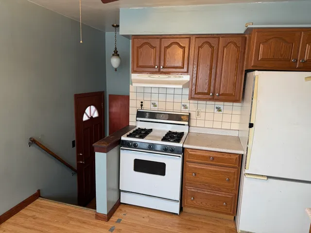 a kitchen with a stove and a refrigerator