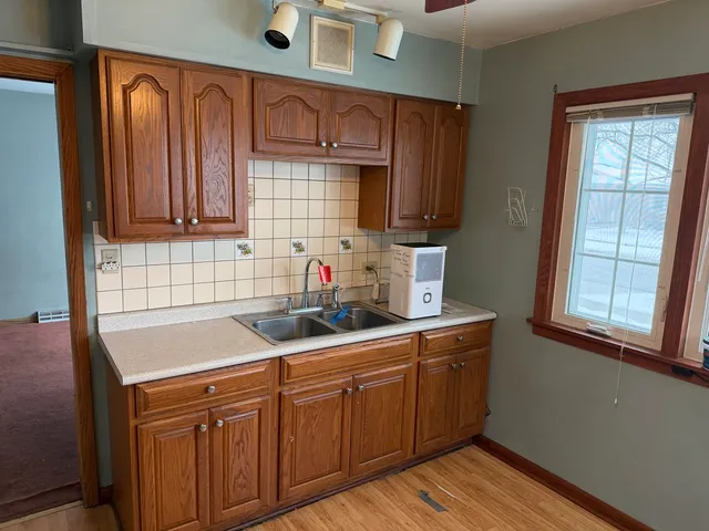 a kitchen with stainless steel appliances granite countertop wooden cabinets a sink and dishwasher