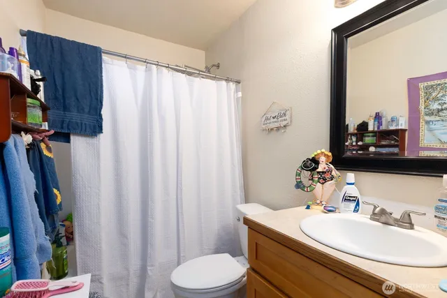 a bathroom with a sink vanity mirror and toilet