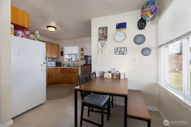 a kitchen with a dining table and chairs