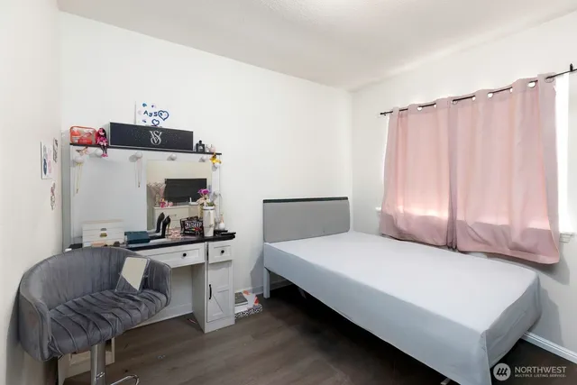 a bedroom with a bed and a chair