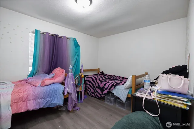 a bedroom with bed and a couch