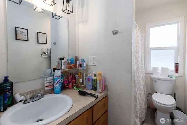 a bathroom with a sink a toilet and a mirror