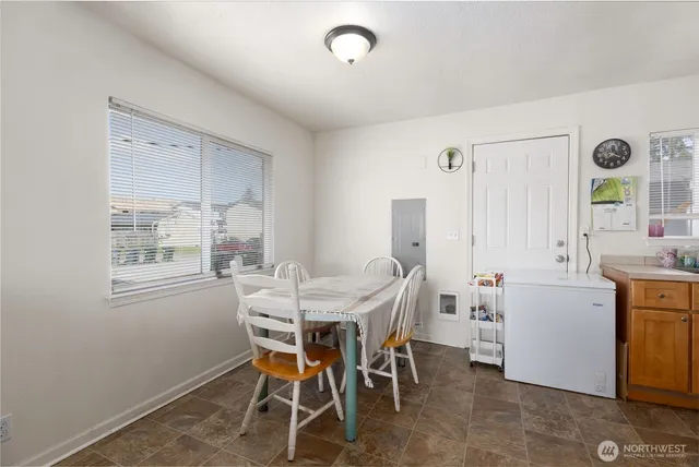 a view of a dining room with furniture and window