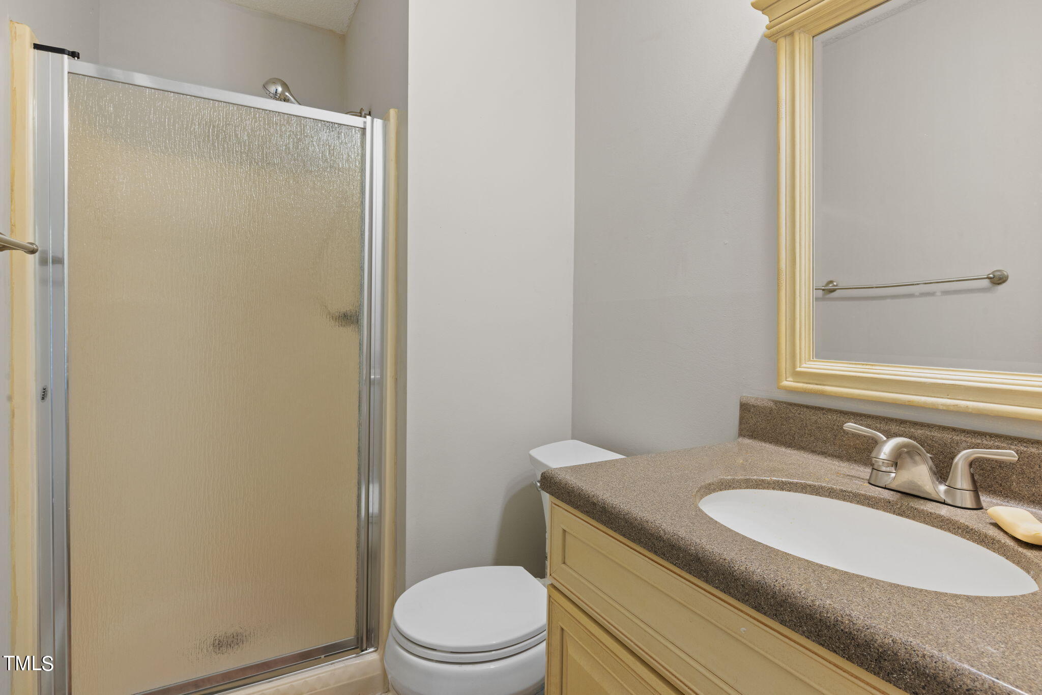5955 Dixon Drive Raleigh, NC 27609 - Photo 13 of 26 a bathroom with a granite countertop sink toilet and shower