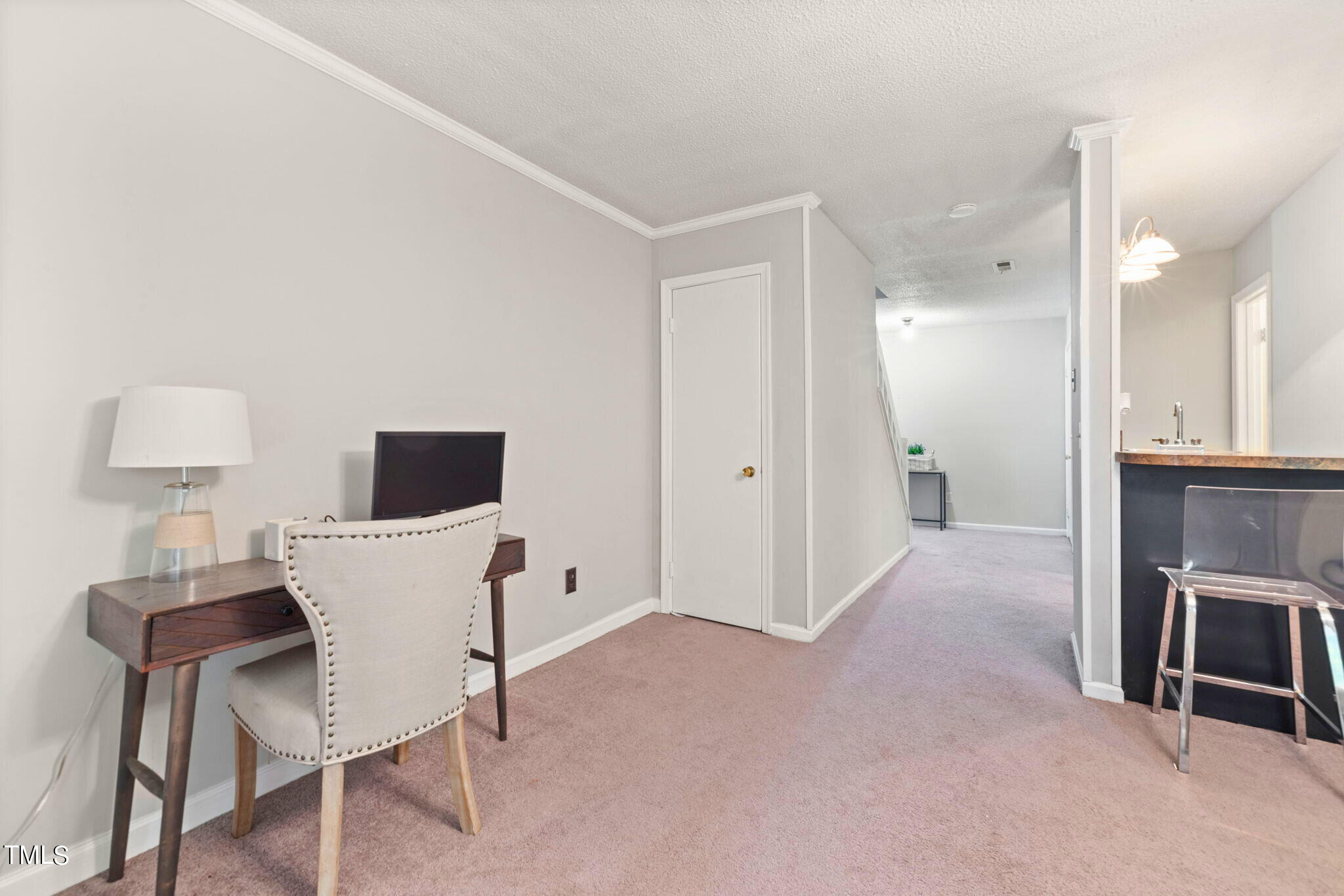 5955 Dixon Drive Raleigh, NC 27609 - Photo 15 of 26 a view of a workspace with furniture and a flat screen tv