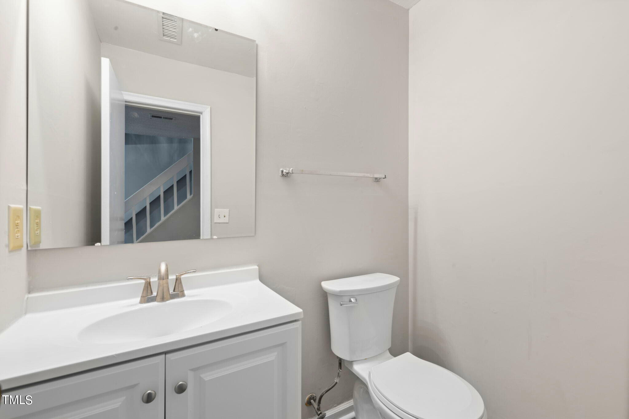 5955 Dixon Drive Raleigh, NC 27609 - Photo 18 of 26 a white toilet sitting next to a bathroom sink