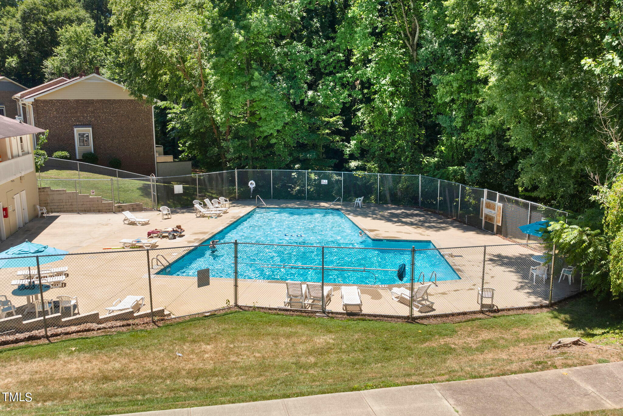 5955 Dixon Drive Raleigh, NC 27609 - Photo 26 of 26 a small white house with a small yard and large trees